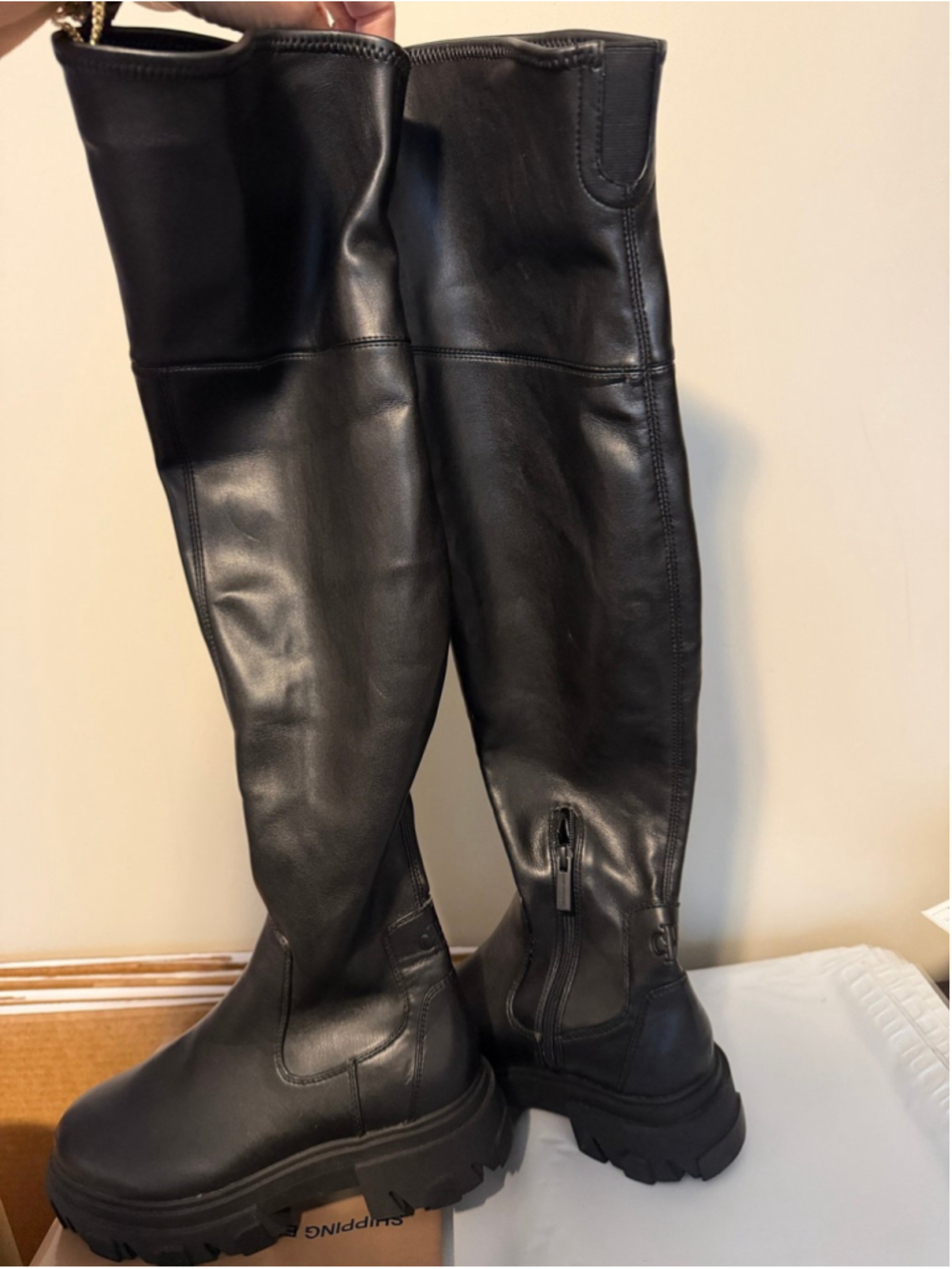 Calvin Klein black chunky platform boots featuring a thick, ridged lug sole.